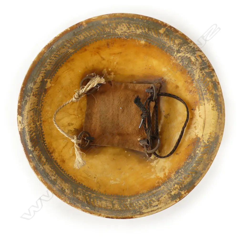 An uncommon Indian hide shield (dhal), probably rhinoceros, circular domed form, with remnant painted border decoration, four petal shaped bosses, Image 1++