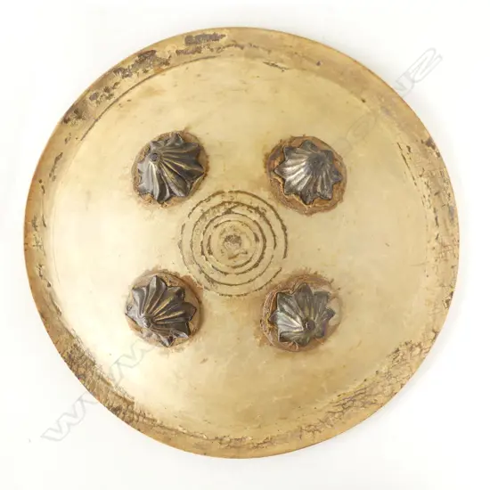 An uncommon Indian hide shield (dhal), probably rhinoceros, circular domed form, with remnant painted border decoration, four petal shaped bosses,
