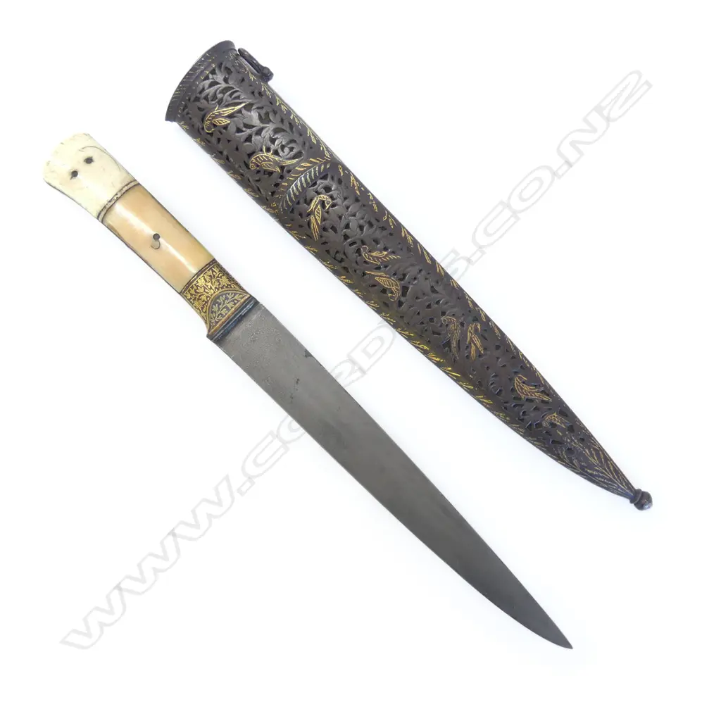 A 19thC Indian kard dagger, in finely pierced and gilded scabbard, the tapering single edged blade of finely watered steel, forte and hilt with gold koftgari and ivory grips, Image 1++