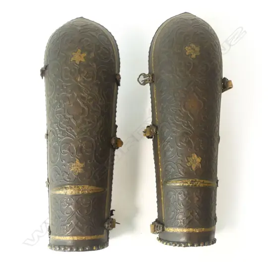 A pair of 18th/19thC Persian bazu-band (forearm armour), iron, with hinged cuff plates, heavily chiseled with foliate tendrils with traces of gilt remaining,