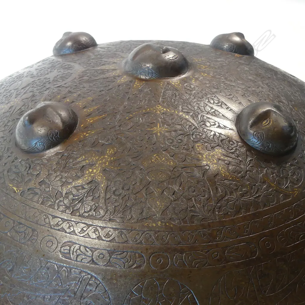 A  good 19thC Persian Qajar circular convex steel shield (sipar), with raised sun mask bosses to the centre, gold damascened and engraved, Image 1++