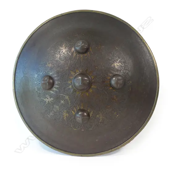 A  good 19thC Persian Qajar circular convex steel shield (sipar), with raised sun mask bosses to the centre, gold damascened and engraved,