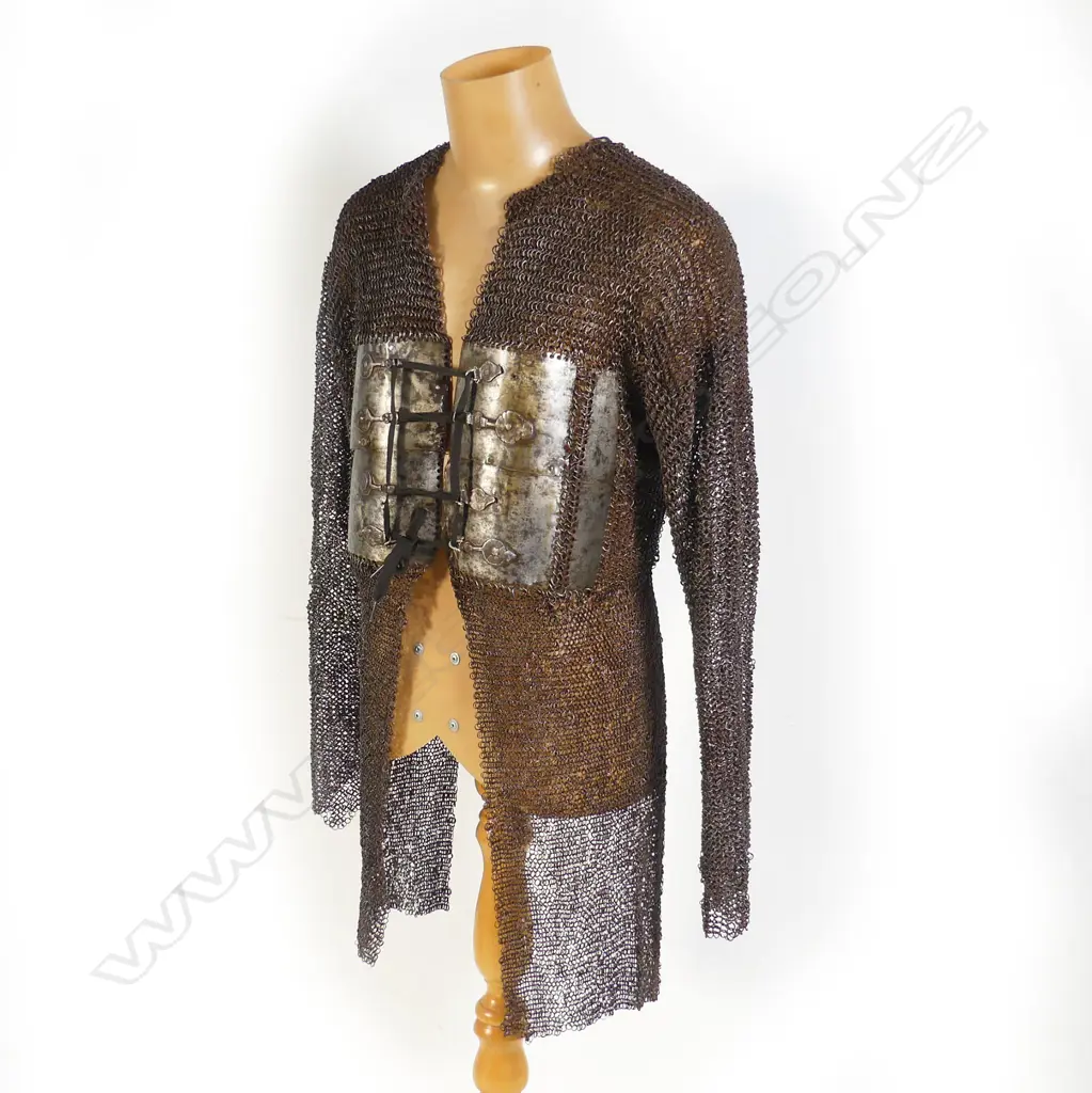 A 17thC Indian mail shirt and head covering with plume. Image 1++