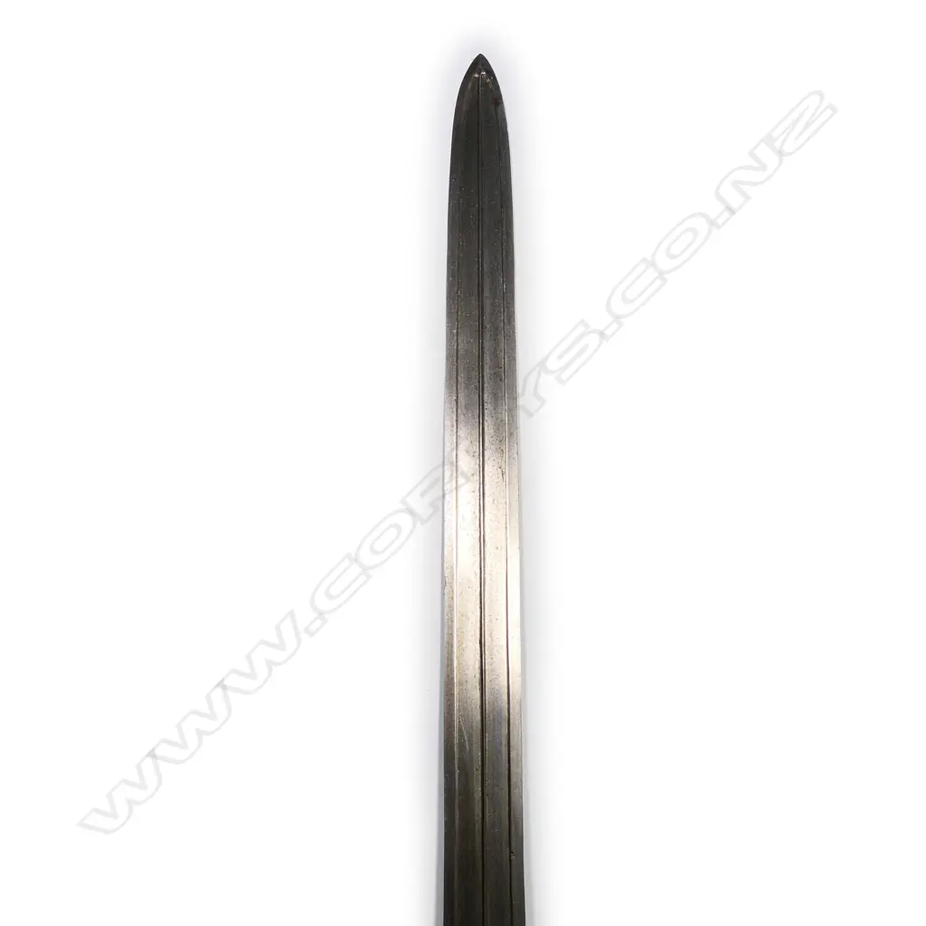 An Indian Pahari sword of unusual form, the broad flat blade with double edge and raised central ridge within a sunken panel. Image 1++