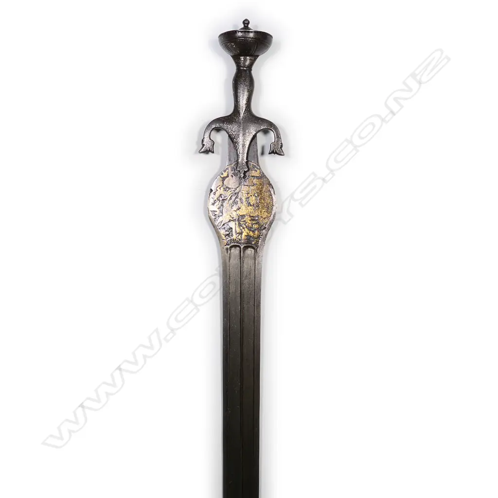 An Indian Pahari sword of unusual form, the broad flat blade with double edge and raised central ridge within a sunken panel. Image 1++