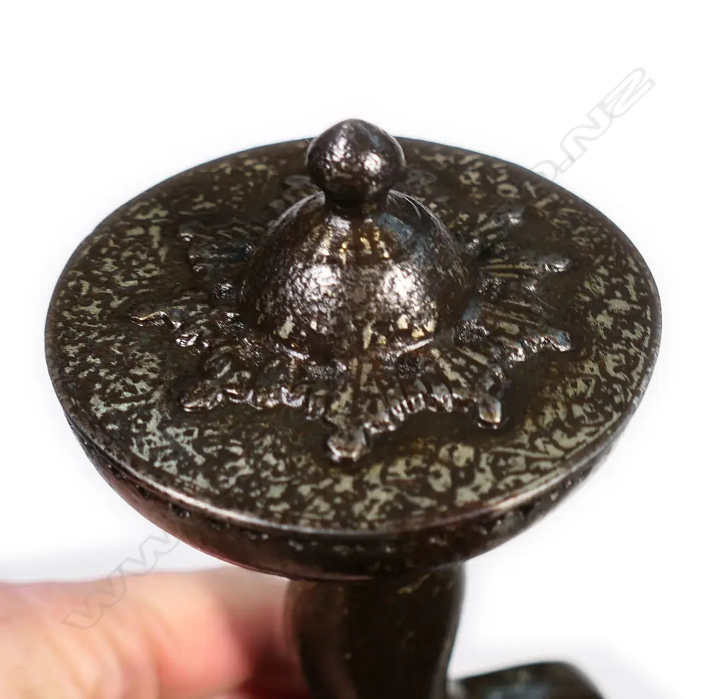 An Indian Pahari sword of unusual form, the broad flat blade with double edge and raised central ridge within a sunken panel. Image 1++