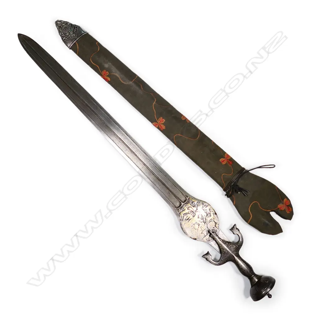 An Indian Pahari sword of unusual form, the broad flat blade with double edge and raised central ridge within a sunken panel. Image 1++