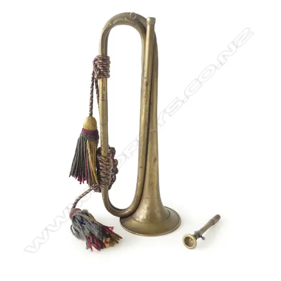 A 19thC brass cavalry bugle, with attached cord and tassels.