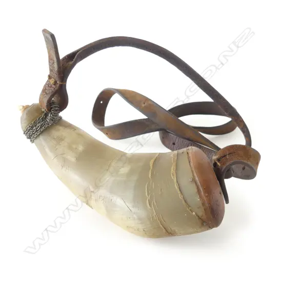 A 19thC ox horn powder flask with leather strap.