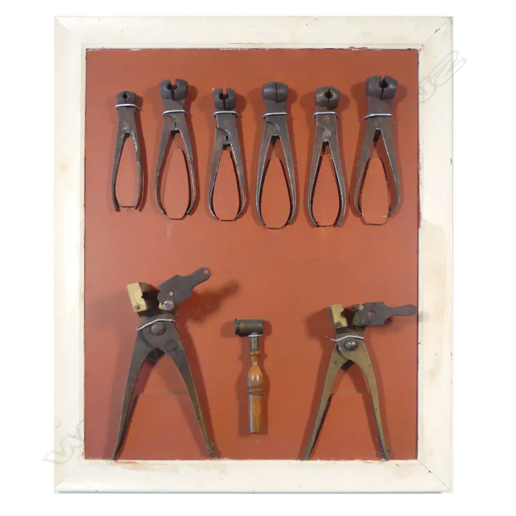 A collection of bullet moulds and powder measure, mounted on display board. Image 1++