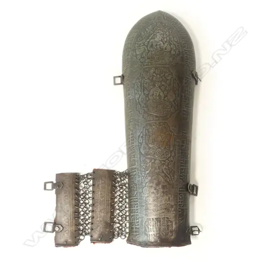 A good single steel 19thC Persian forearm armour (bazu-band), with etched figurative panels within a border of Islamic script,