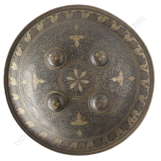 A late 19th/early 20thC Indian fist shield, circular domed shape with four bosses and ogee shaped border,