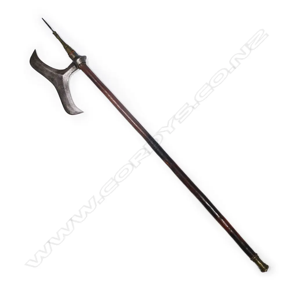 An Indian axe with steel blade, decorated and brass mounted spike, wooden shaft and brass pommel. L.1016mm. Image 1++