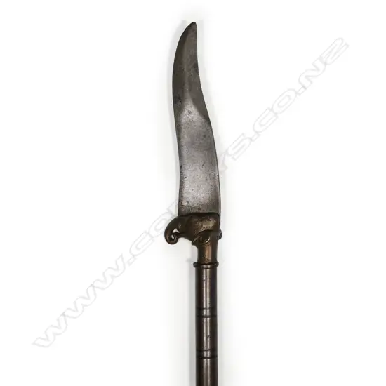 An Indian elephant head dagger, with clip pointed steel blade on brass elephant head mount,