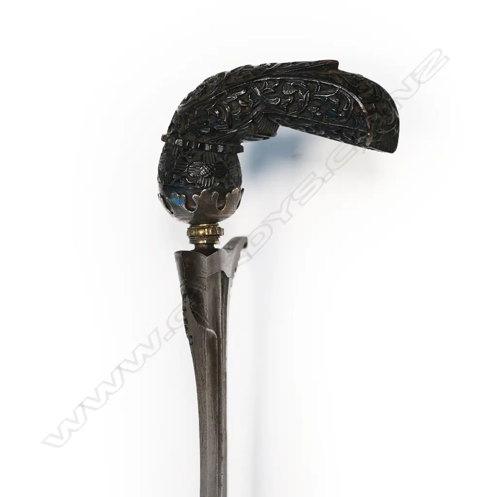 A Javanese Kris with wavy edged tapering iron blade, hardwood hilt covered with flowers and scrolling foliage, Image 1++