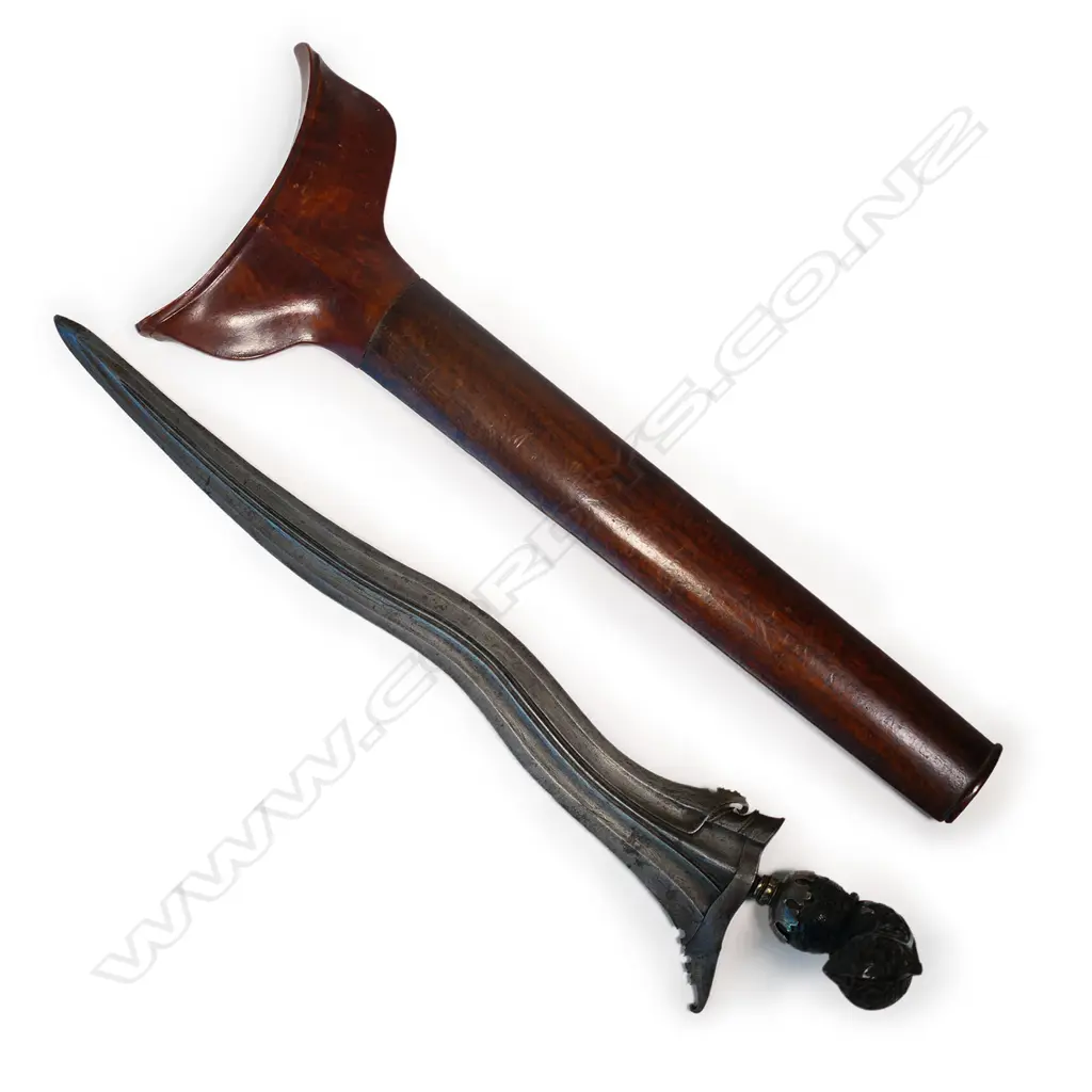 A Javanese Kris with wavy edged tapering iron blade, hardwood hilt covered with flowers and scrolling foliage, Image 1++