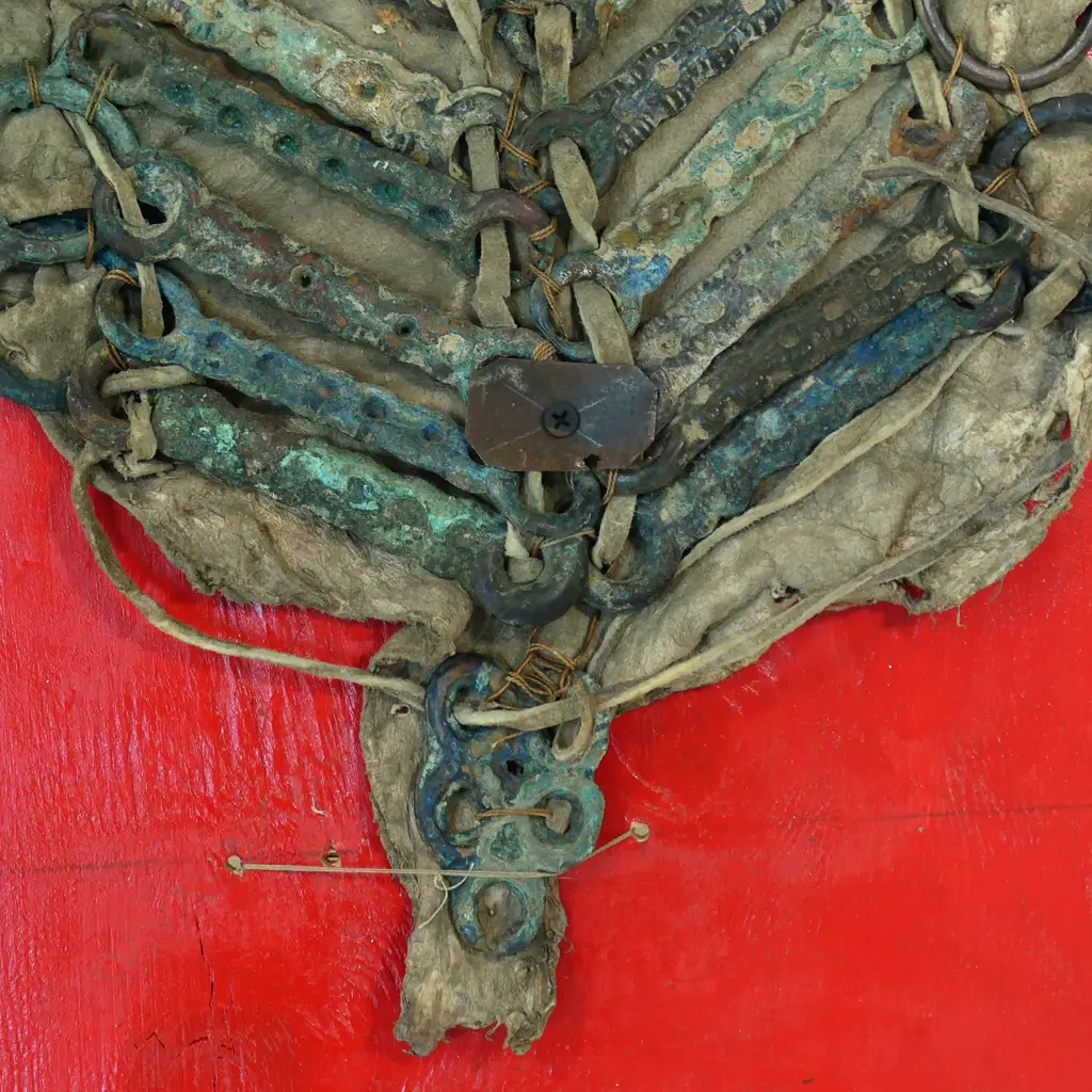Archaic style, verdigris patinated bronze rings and bars reputedly Sung Dynasty (AD960-1126) horse armour, thong strung and mounted on a leather panel. Image 1++