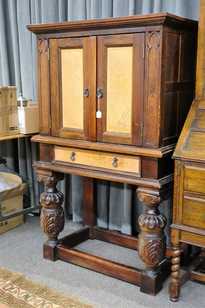 A small vintage Southland Beech two-door cabinet of English Tudor style Image 1++