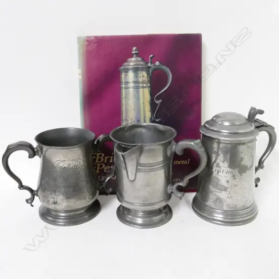 Three pewter vessels and a book