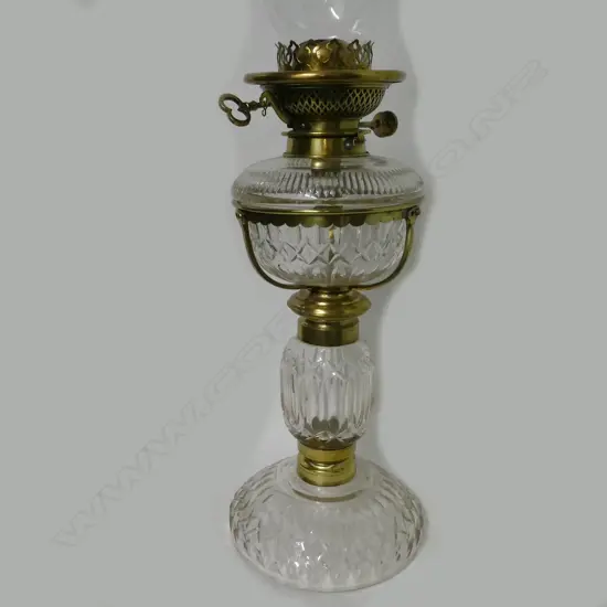 A cut crystal and brass kerosene lamp