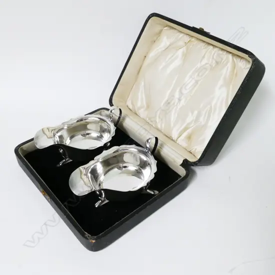 A cased pair of silver sauce boats