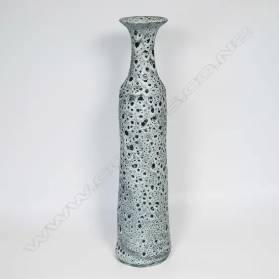 Graham Ambrose bubble glaze long bottle vase; the pale grey glaze on dark ground, long tapered cylindrical body. Impressed potters mark to base. H.540mm. Note: This unique high fired bubble glaze is one of four pieces made late 1990's early 2000's.