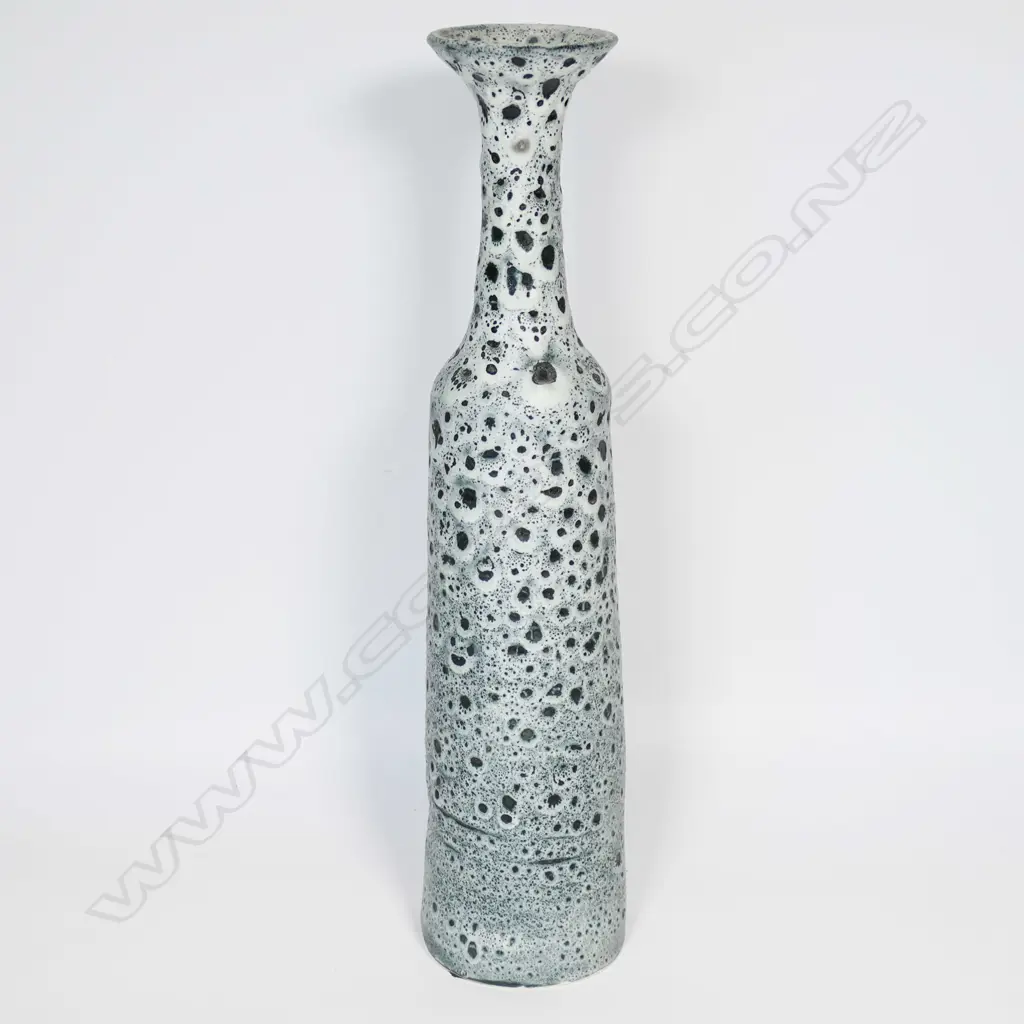Graham Ambrose bubble glaze long bottle vase; the pale grey glaze on dark ground, long tapered cylindrical body. Impressed potters mark to base. H.510mm. Note: This unique high fired bubble glaze is one of four pieces made late 1990's early 2000's. Image 1++