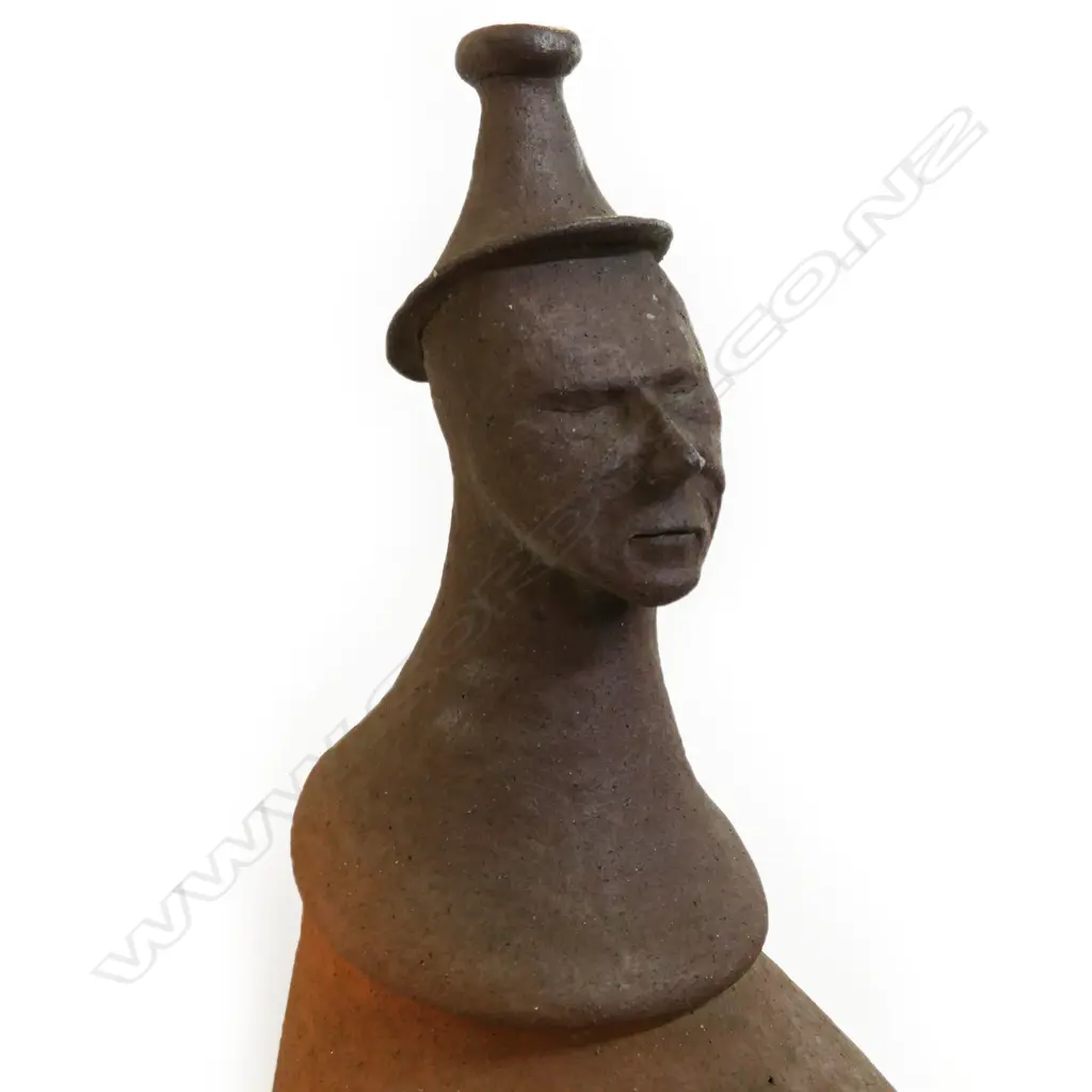 Barry Brickell (1935-2016) wood fired terracotta sculpture. A hand built anthropomorphic form morphing into a hatted bust, lower section of the stylised leg form with curved base. Unglazed with natural kiln firing variation. Chip and surface loss to foot edge. H.1250mm, Image 1++