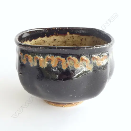 Barry Brickell (1935-2016) lobe sided stoneware bowl with lustrous tenmoko glazed square form with squiggle design under rim. Potter's mark impressed to side. H.150mm