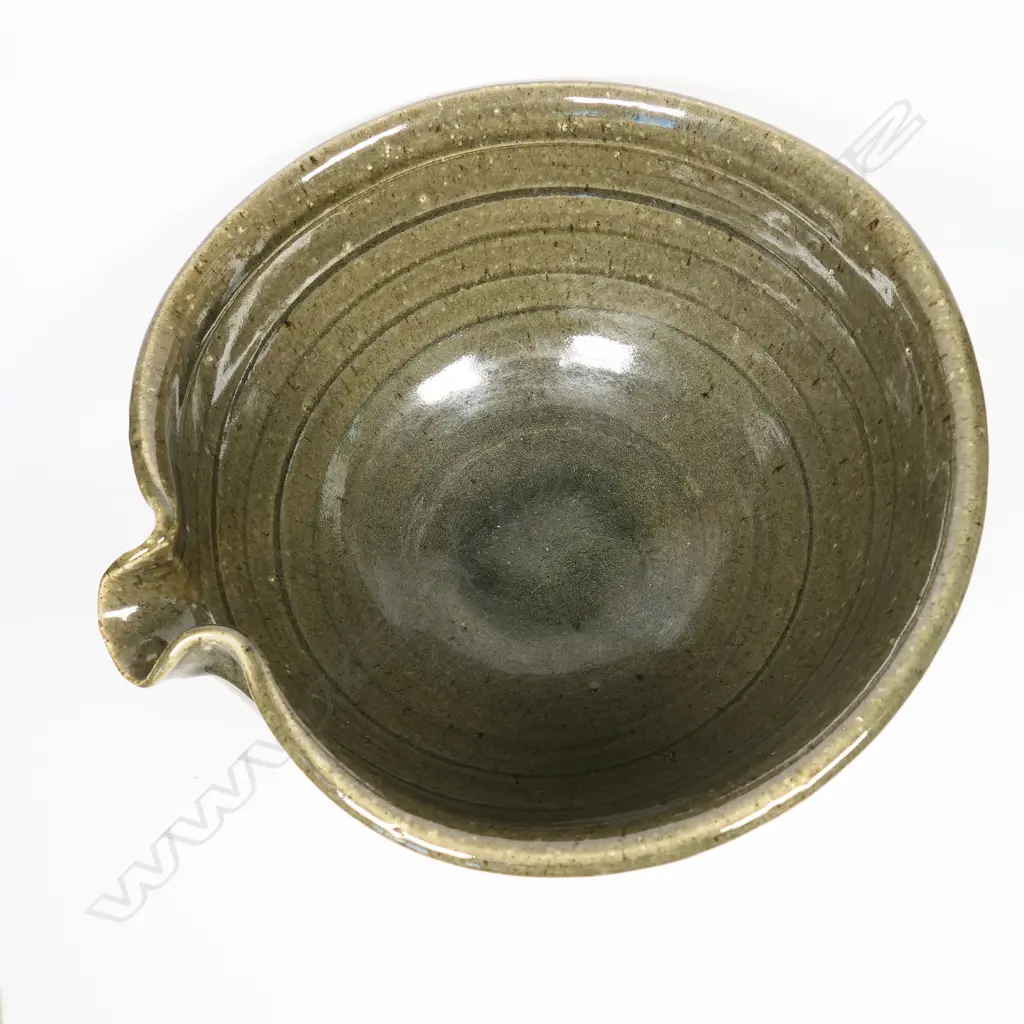 Len Castle (1924-2011) large green glaze pouring bowl; small rondels impressed to the rim. Banded throwing marks evident. Unglazed foot, with potter's mark. Dia.305mm. Image 1++
