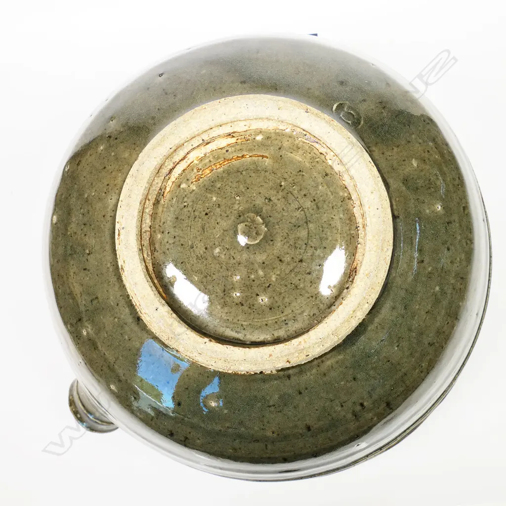 Len Castle (1924-2011) large green glaze pouring bowl; small rondels impressed to the rim. Banded throwing marks evident. Unglazed foot, with potter's mark. Dia.305mm. Image 1++