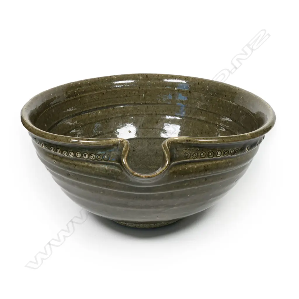 Len Castle (1924-2011) large green glaze pouring bowl; small rondels impressed to the rim. Banded throwing marks evident. Unglazed foot, with potter's mark. Dia.305mm. Image 1++