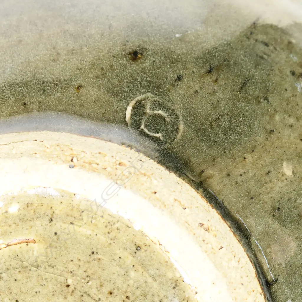 Len Castle (1924-2011) large green glaze pouring bowl; small rondels impressed to the rim. Banded throwing marks evident. Unglazed foot, with potter's mark. Dia.305mm. Image 1++