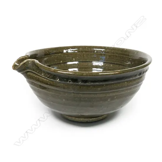 Len Castle (1924-2011) large green glaze pouring bowl; small rondels impressed to the rim. Banded throwing marks evident. Unglazed foot, with potter's mark. Dia.305mm.