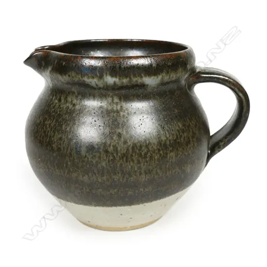 Len Castle jug spherical form ¾ dark green/brown glaze. Impressed mark. H.110mm. Vendor's note: Bought directly from the potter.