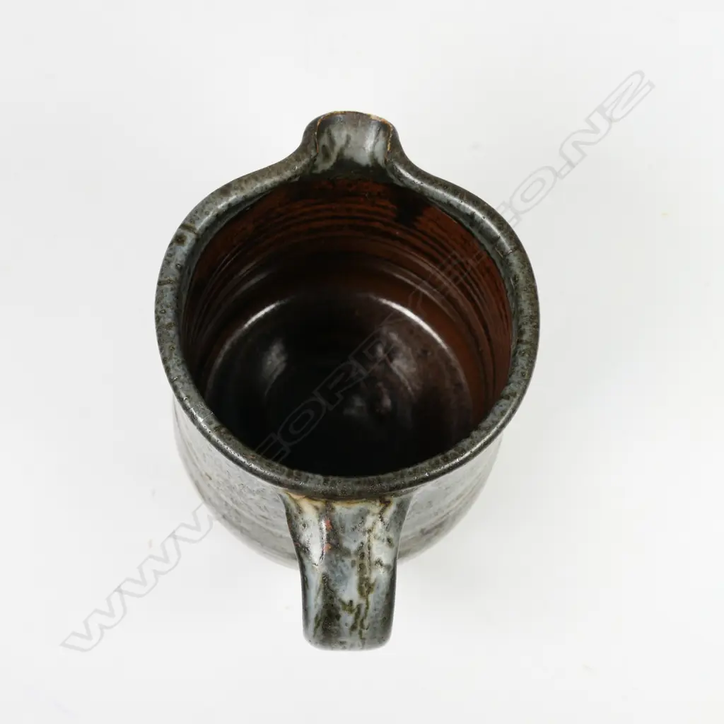 Len Castle jug of tapered cylinder form with variable dark grey glaze. Impressed mark. H.115mm. Vendor's note: Bought directly from the potter. Image 1++