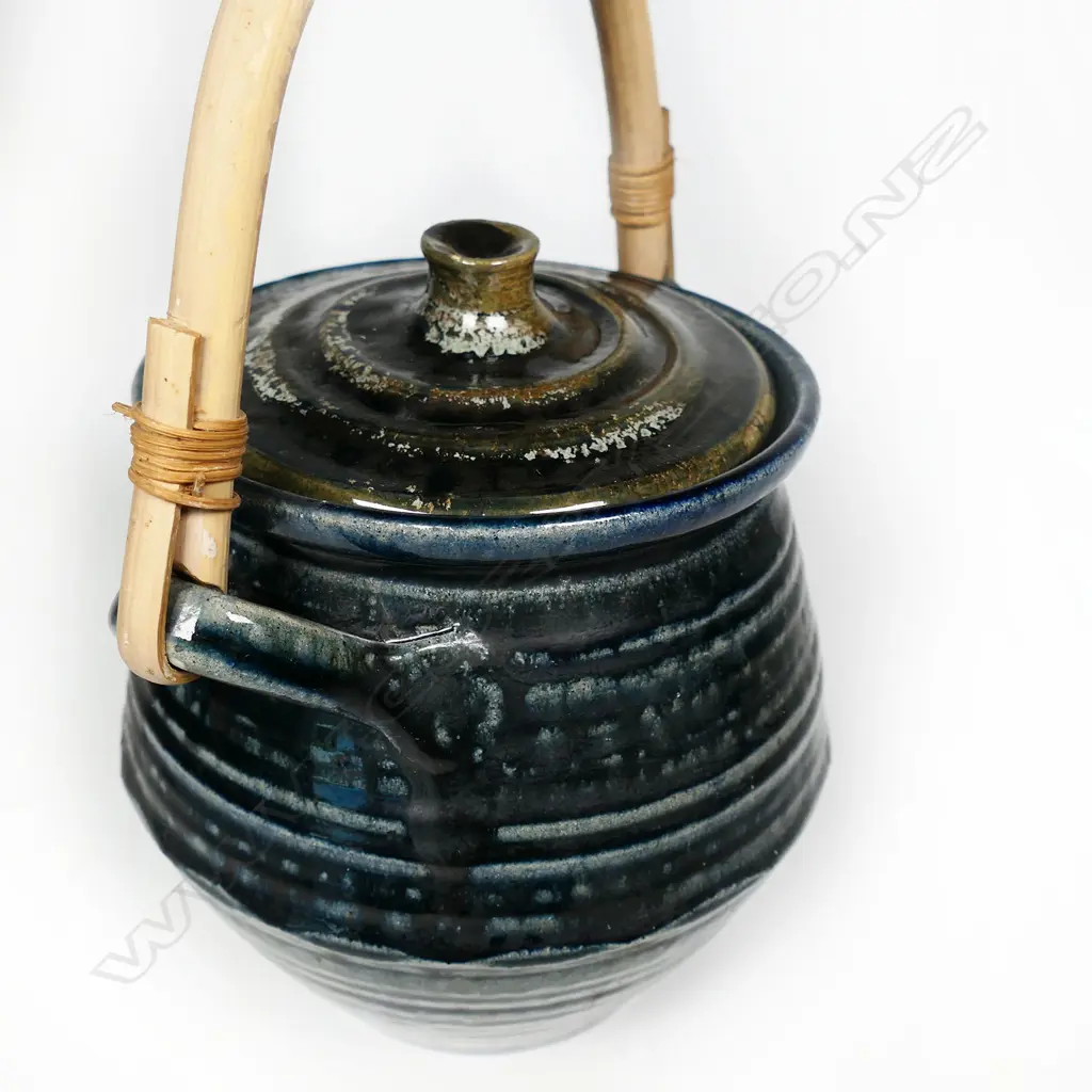 Peter Stichbury (1924-2015) 1960's/1970's salt glazed large biscuit barrel with cobalt blue tones, ridged lid with knob handle, small chip. Bamboo over-head handle. H.275mm. To top of handle. Image 1++