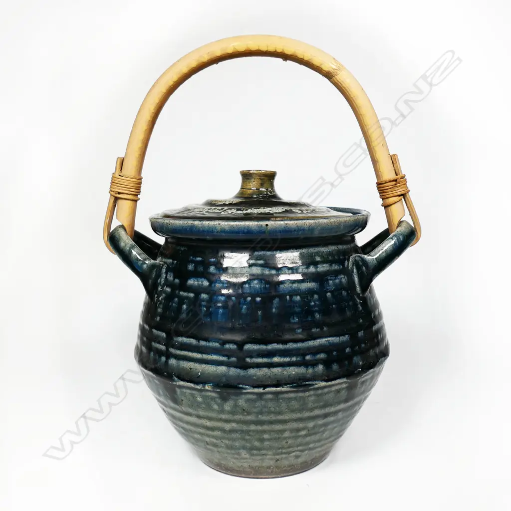 Peter Stichbury (1924-2015) 1960's/1970's salt glazed large biscuit barrel with cobalt blue tones, ridged lid with knob handle, small chip. Bamboo over-head handle. H.275mm. To top of handle. Image 1++