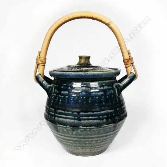 Peter Stichbury (1924-2015) 1960's/1970's salt glazed large biscuit barrel with cobalt blue tones, ridged lid with knob handle, small chip. Bamboo over-head handle. H.275mm. To top of handle.