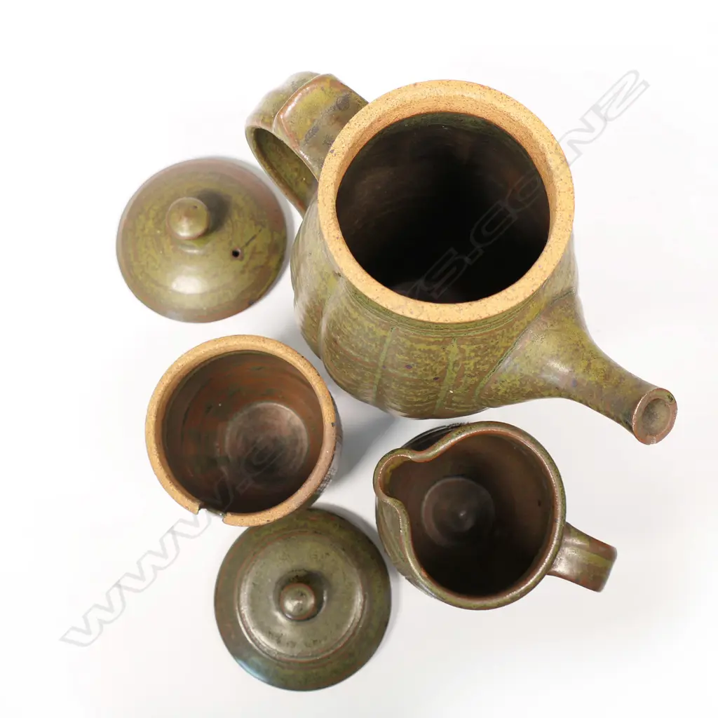 Peter Stichbury (1924-2015) three-piece coffee set - comprising coffee pot, lidded sugar and cream jug. Rock ash glaze. Vertical incised detail. Impressed potter's mark. H.240mm (coffee pot). Image 1++