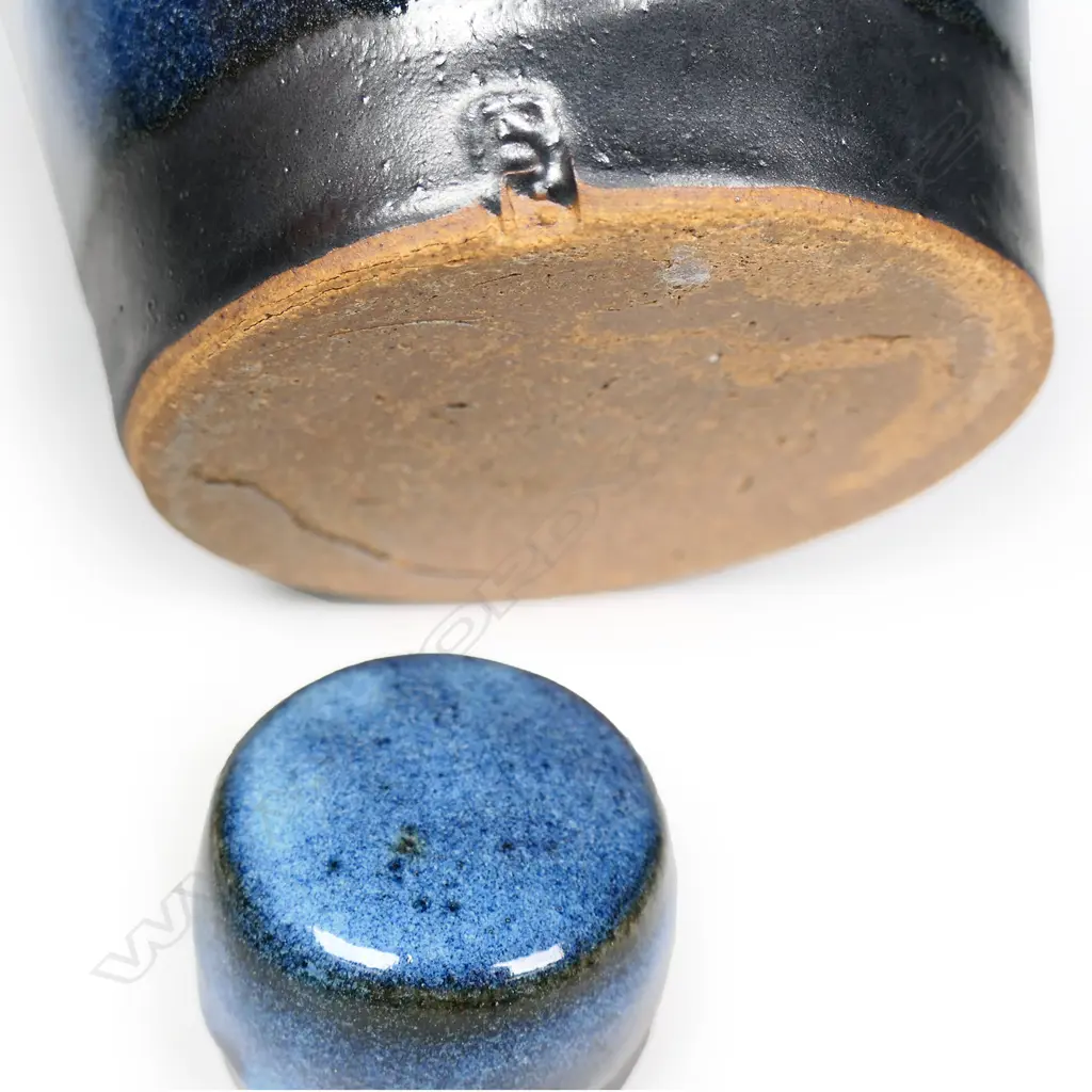 Peter Stichbury chun glazed large-sized tea caddy with screw lid -  speckled pale and blue glaze effects with matte black glaze band to the base of the lid and body. Impressed potter's mark. H.180mm.  Provenance: From a potter's collection. Image 1++