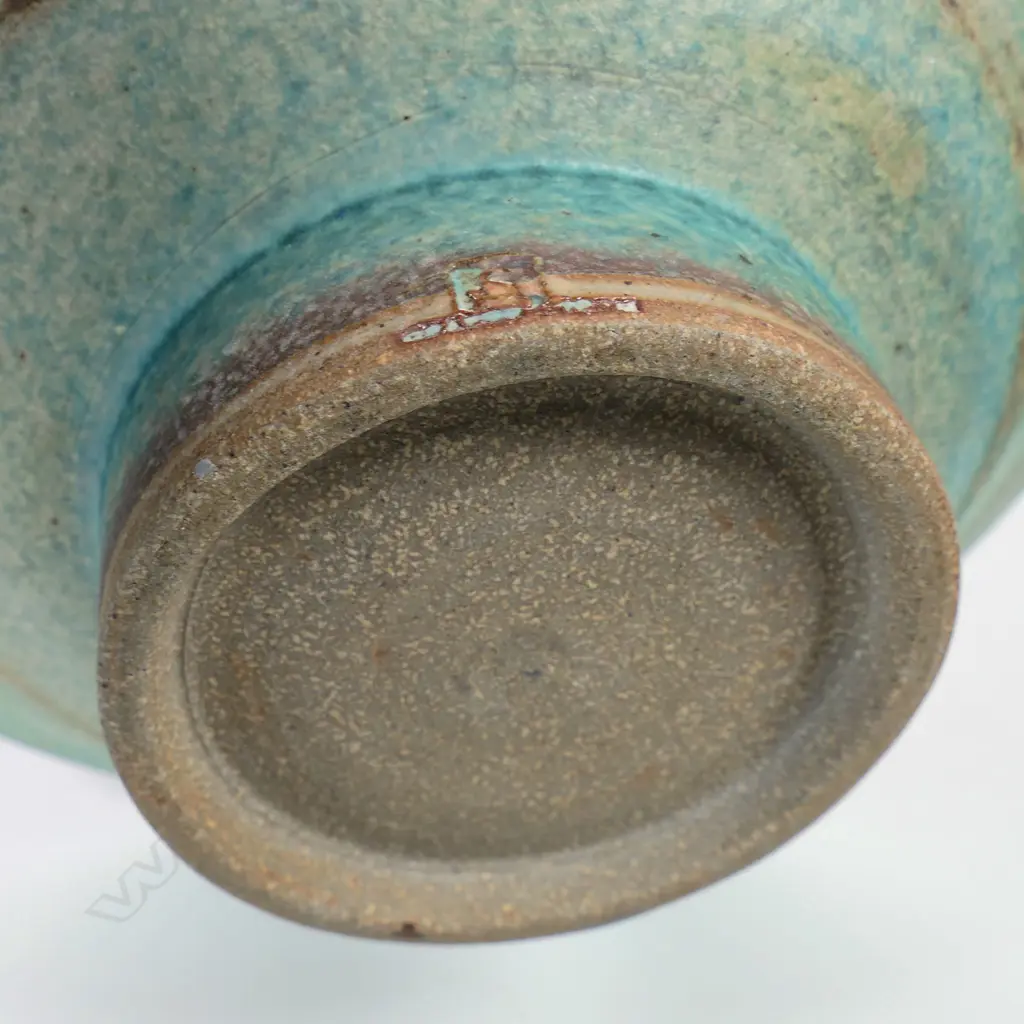 Two Graeme Storm pottery pieces - both with faults, turquoise glazed footed bowl with central well, small chip and glaze loss to rim, dia.200mm. Ovoid vase with lug handle, chip to lip and star crack to base, 150mm. Potter's mark to base of both. Image 1++
