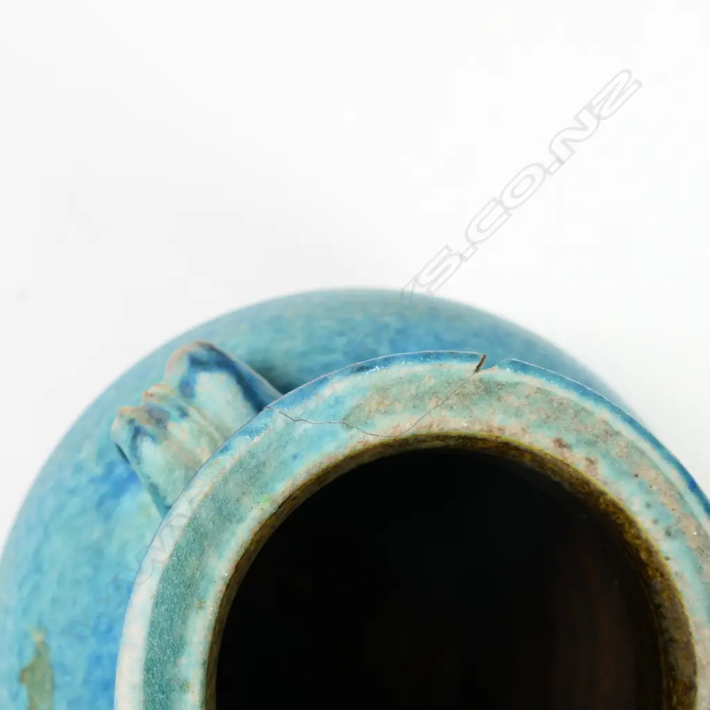 Two Graeme Storm pottery pieces - both with faults, turquoise glazed footed bowl with central well, small chip and glaze loss to rim, dia.200mm. Ovoid vase with lug handle, chip to lip and star crack to base, 150mm. Potter's mark to base of both. Image 1++
