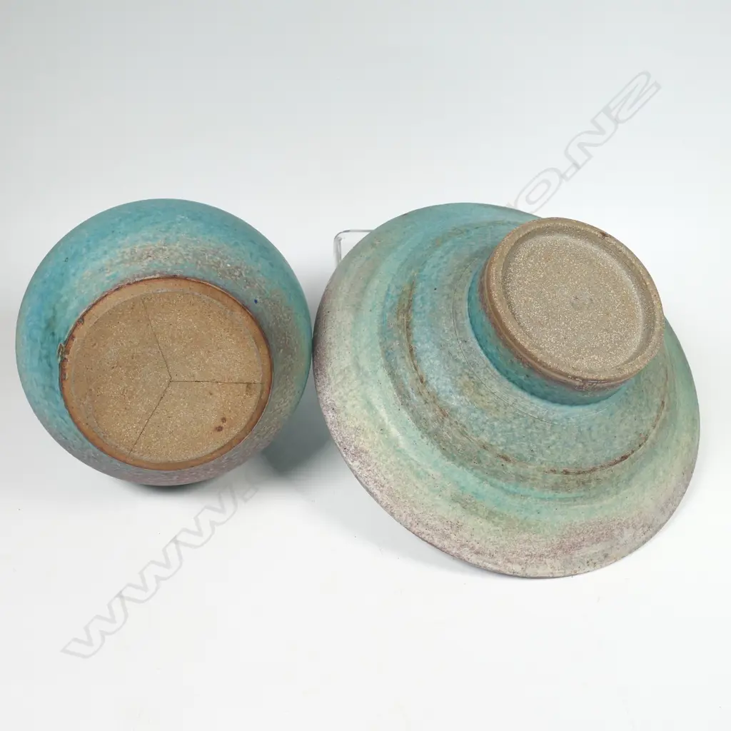 Two Graeme Storm pottery pieces - both with faults, turquoise glazed footed bowl with central well, small chip and glaze loss to rim, dia.200mm. Ovoid vase with lug handle, chip to lip and star crack to base, 150mm. Potter's mark to base of both. Image 1++
