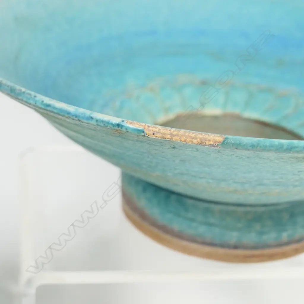Two Graeme Storm pottery pieces - both with faults, turquoise glazed footed bowl with central well, small chip and glaze loss to rim, dia.200mm. Ovoid vase with lug handle, chip to lip and star crack to base, 150mm. Potter's mark to base of both. Image 1++