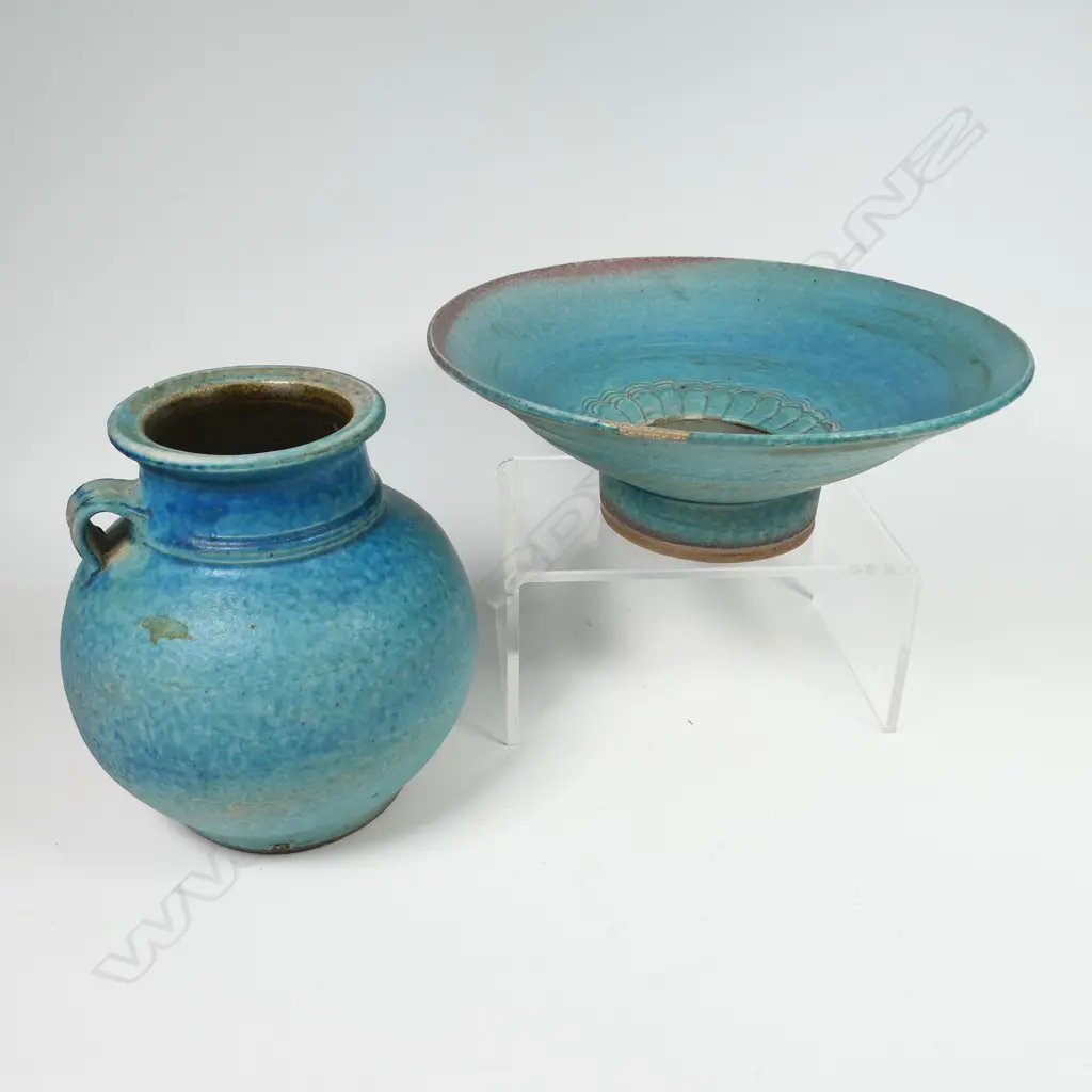 Two Graeme Storm pottery pieces - both with faults, turquoise glazed footed bowl with central well, small chip and glaze loss to rim, dia.200mm. Ovoid vase with lug handle, chip to lip and star crack to base, 150mm. Potter's mark to base of both. Image 1++