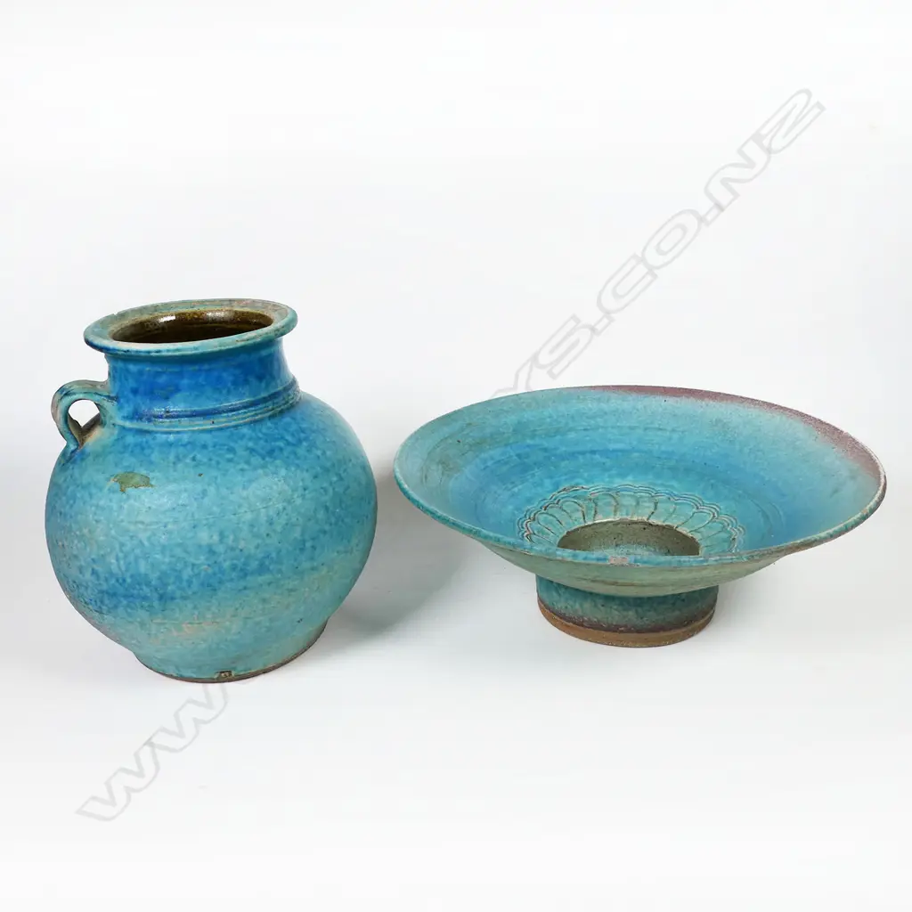 Two Graeme Storm pottery pieces - both with faults, turquoise glazed footed bowl with central well, small chip and glaze loss to rim, dia.200mm. Ovoid vase with lug handle, chip to lip and star crack to base, 150mm. Potter's mark to base of both. Image 1++
