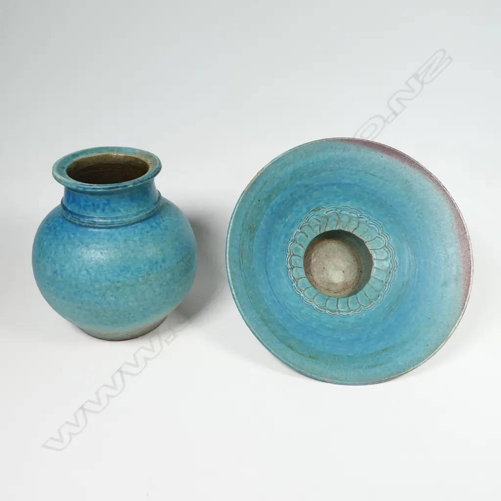 Two Graeme Storm pottery pieces - both with faults, turquoise glazed footed bowl with central well, small chip and glaze loss to rim, dia.200mm. Ovoid vase with lug handle, chip to lip and star crack to base, 150mm. Potter's mark to base of both. Image 1++