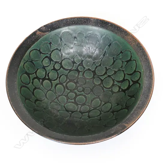 Graeme Storm large bowl - wax resist green glaze patterned decoration on iron glaze ground. Impressed potter's mark. Dia.375mm.