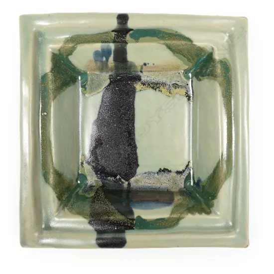 Doreen Blumhardt square platter with abstract poured coloured glaze. Flared rim. Raised on bracket feet Impressed potter's mark. 250 x 250mm.